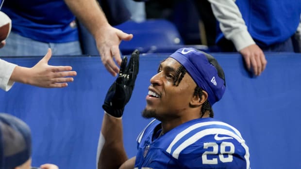 Colts running back Jonathan Taylor high-fives fans after a win over the Buccaneers.